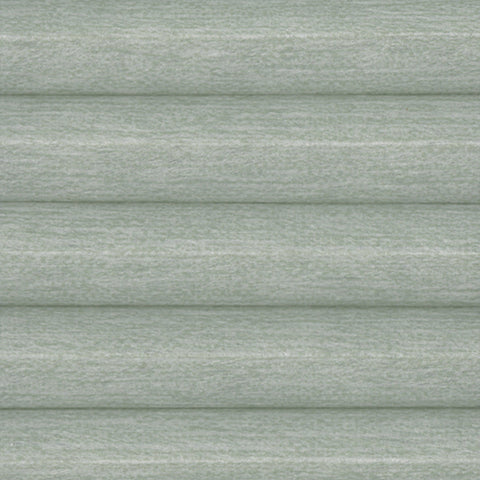 A close up of a honeycomb pleated blind in Fresco Muted Sage. A sage Green light filtering cellular blind providing thermal efficiency.